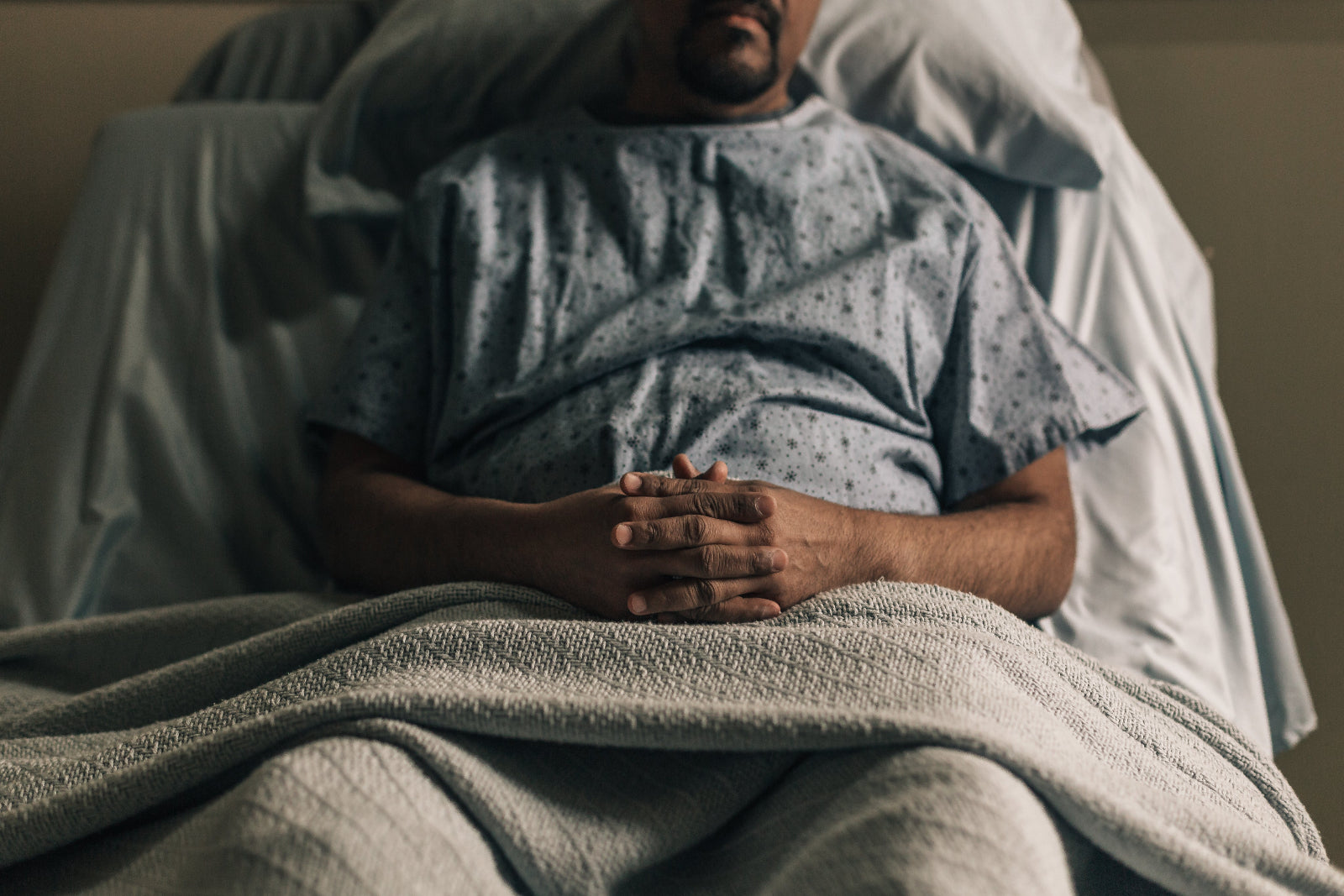 a man propped up in hospita bed