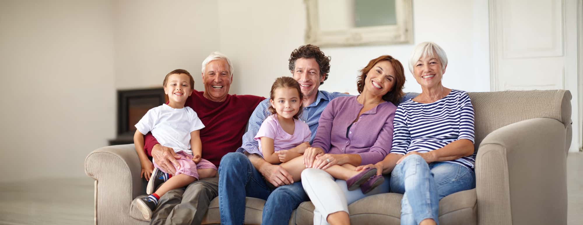 Family of six sitting on a couch in a living room