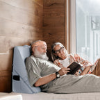 An elderly couple read a book while using kekoy wedge pillow for back support