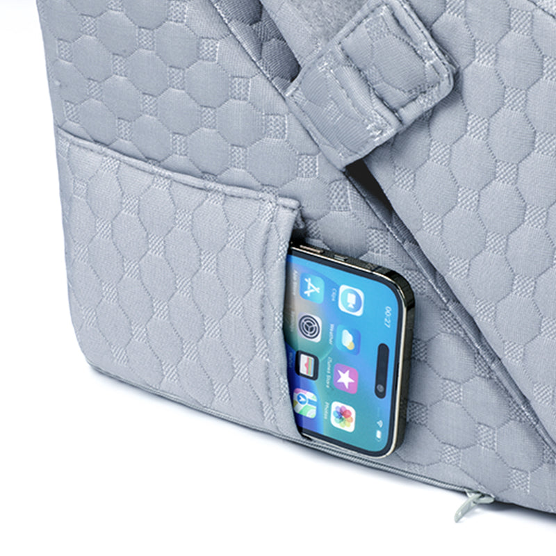 a smartphone tucked into the wedge pillow side
