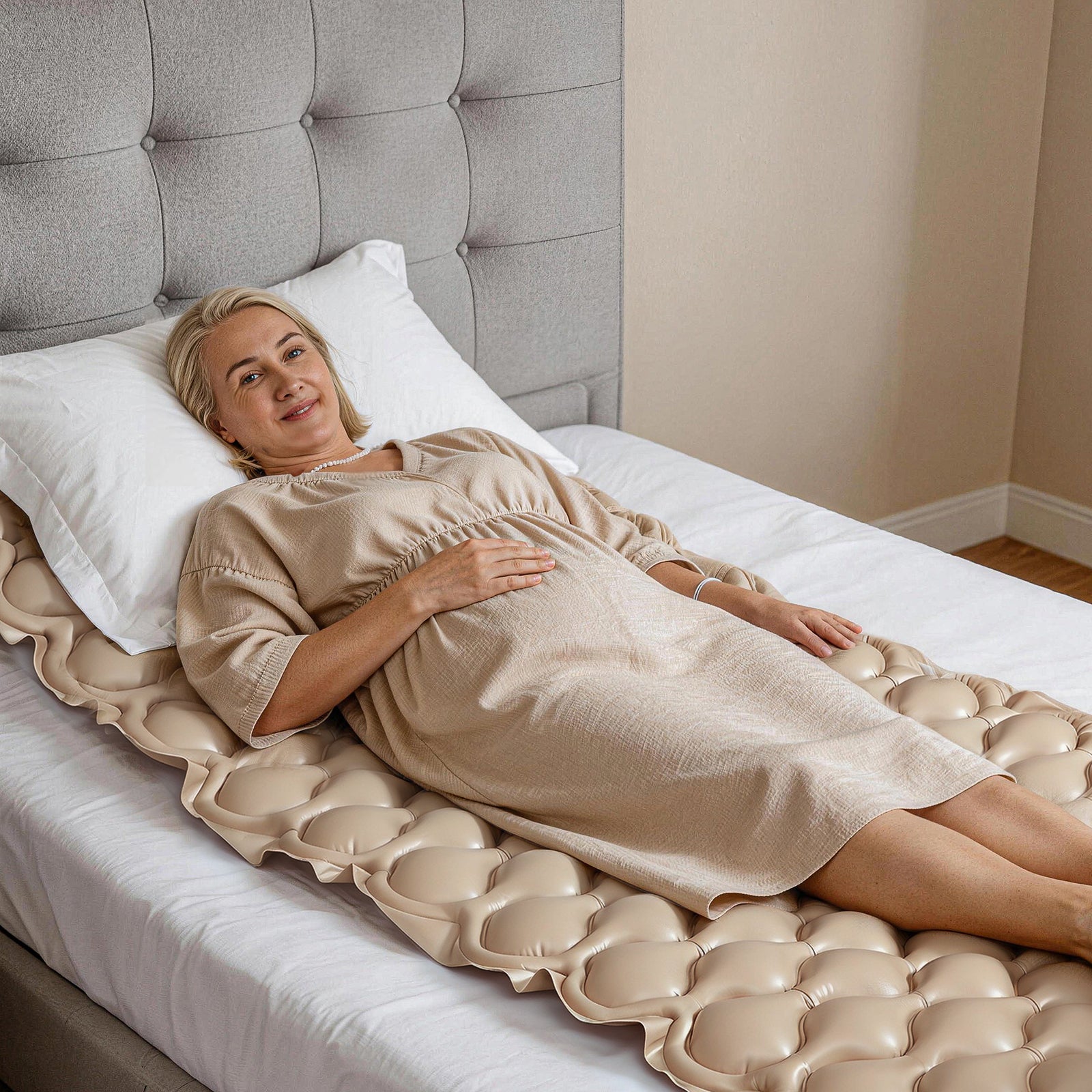 Woman lying on a beige kekoy inflatable mattress in a bedroom.