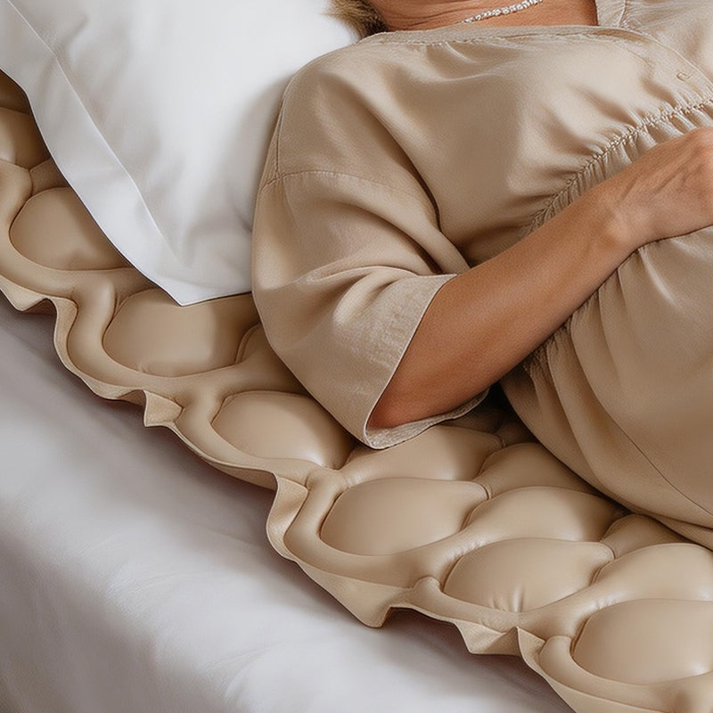 Person lying on a textured beige mattress pad
