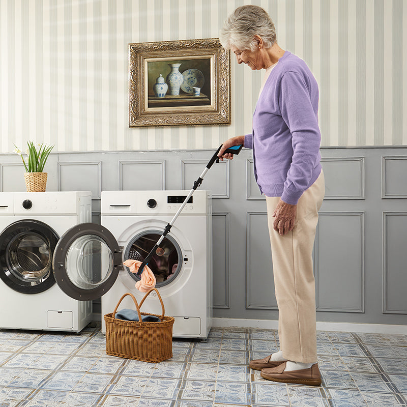 Person using kekoy reacher in the laundry room