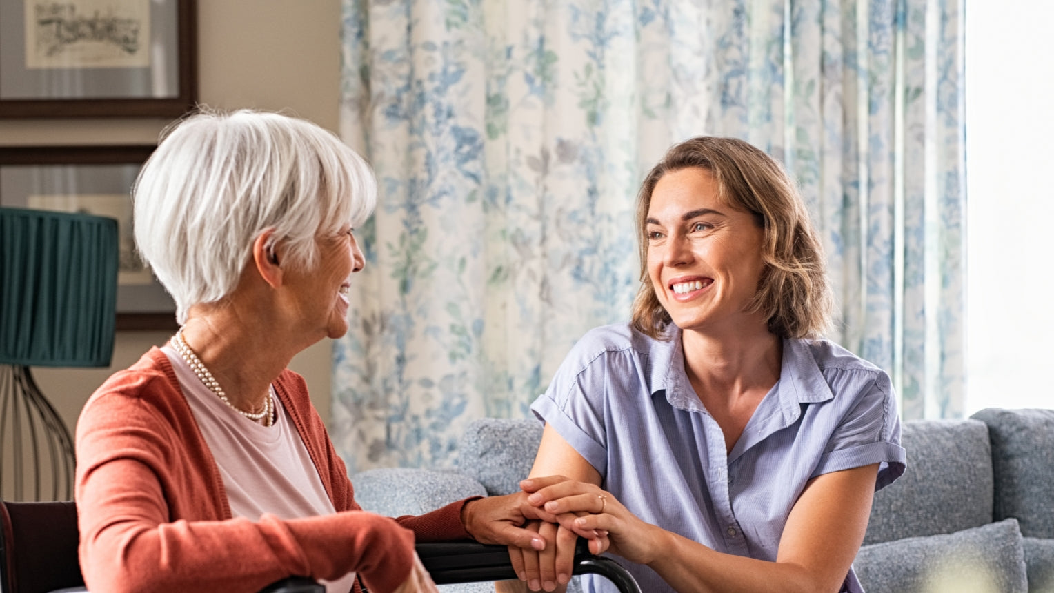 Two women holding hands and smiling