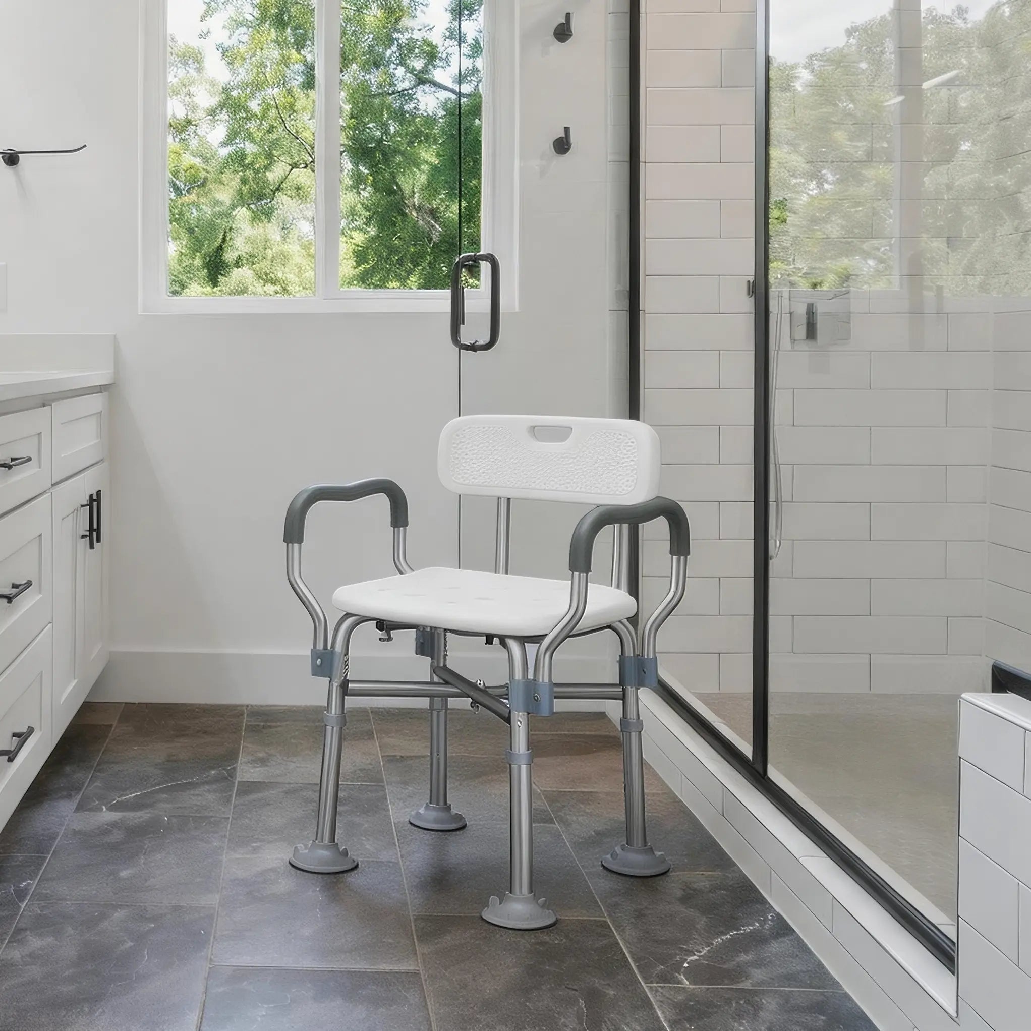 White kekoy shower chair with gray arms and legs in a bathroom setting.