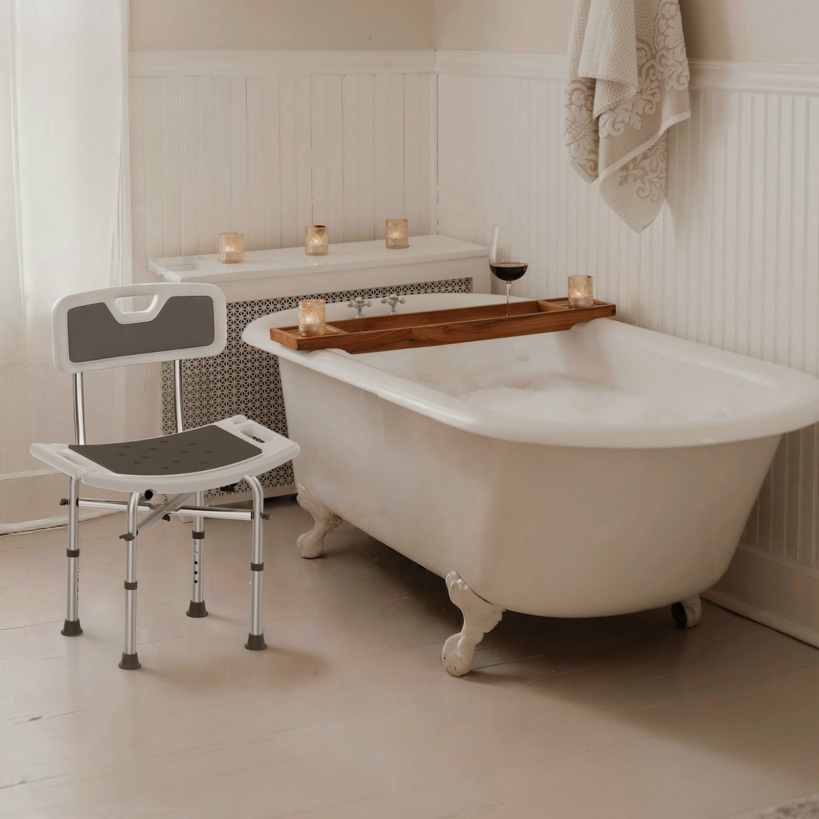 Bathroom with a clawfoot bathtub, shower chair, and candles.