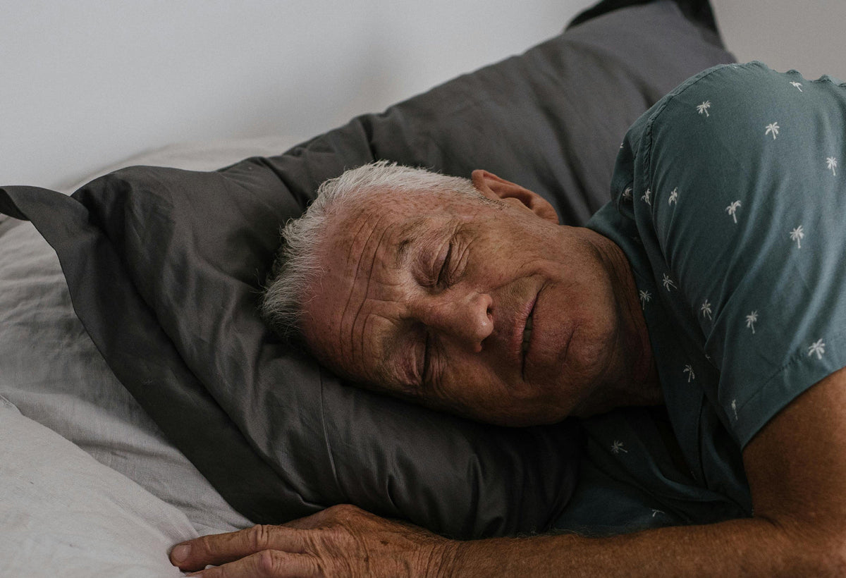 Man sleeping peacefully on a bed